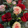 Bouquet of red and blush roses with small purple filler flowers