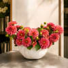 Pink dahlia arrangement in a white bowl vase
