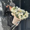 Large bouquet of white and blush flowers in a beige hatbox