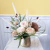 The combination of pale pink roses, white blooms, dried blooms and the