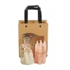 Gift bag with a glass bottle, dried flowers, and pink candles