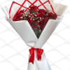 Red roses wrapped in white paper with a gold "I love you" card