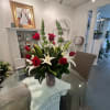 Red roses and white lilies arranged in a glass vase