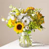 Bouquet of sunflowers and white daisies in a clear glass vase