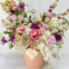 Mixed pink and white flower arrangement in a peach hat box