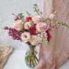 Pink and cream rose bouquet in a clear glass vase