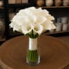 White calla lily bouquet in a clear glass vase