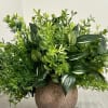 The greenery composition is designed with faux plants and assorted faux greenery