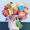 Pink and peach roses with Ghirardelli chocolates in a pink vase