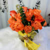 Orange rose bouquet wrapped with yellow mesh ribbon