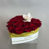 Red roses in a white hat box with a white orchid on top