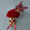 Red rose arrangement in a gold bust vase with a red ribbon