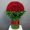 Large dome of red roses with green foliage and wrapped stems