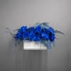 Blue rose arrangement in a white rectangular container