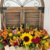 Long centerpiece in wood box with all  fall flowers in plain