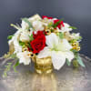 Bouquet of red roses and white lilies in a gold vase
