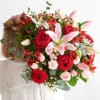 Red roses and lilies. Together, they compose a vibrant harmony of red