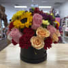 Mixed bouquet of sunflowers, roses, and carnations in a black box