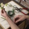 Custom floral boutonniere designed with florals, and greenery. Includes two pins