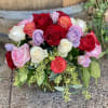 A gorgeous compact arrangement of colorful roses and eucalyptus.
