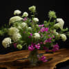 Tall bouquet of white and magenta flowers in a clear glass vase