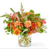 Orange and pink bouquet in a clear glass vase
