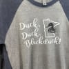 Gray and navy raglan T-shirt with a duck graphic and text