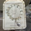 Beaded First Communion bracelet on a printed card