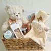 Baby gift basket with teddy bears, blanket, pacifier, and feeding items