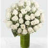 White rose bouquet in a tall green glass vase
