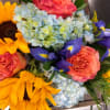 Big golden sunflowers take center stage in this cheerful flower arrangement, making