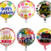 Six round birthday balloons with colorful printed designs