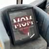 Framed arrangement of red roses with a "Mom" message