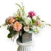 Mixed bouquet in a square wooden vase with pink, white, and peach blooms