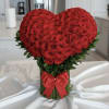 Heart-shaped bouquet of red roses with a red ribbon