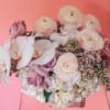 Bouquet of pale pink and white flowers in a clear vase