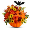 Pumpkin arrangement with roses and daisies, topped with a bat decoration