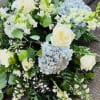White and pale blue wedding bouquet with roses and hydrangeas
