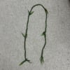 Braided green floral garland on a gray surface