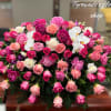 Large pink and white rose and peony casket spray with white orchids