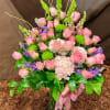 Tall pink rose and hydrangea arrangement with green mums and bells of Ireland in a glass vase
