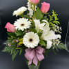 A radiant tribute filled with love and light. This elegant arrangement speaks