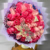 Round bouquet of hot pink and light pink roses with purple filler, wrapped in pastel paper with butterfly accents