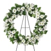 White daisy wreath on a black metal stand