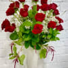 Red roses arranged in a white textured vase