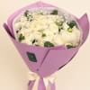 Bouquet of white ranunculus wrapped in lavender paper with a ribbon