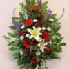 Standing floral spray with red, white, yellow, and purple flowers