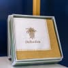 Boxed napkins with a gold pineapple logo and trim