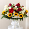 Mixed bouquet of red and white roses with sunflowers in a white vase