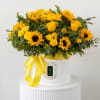 Yellow sunflowers and roses arranged in a white hat box with a yellow ribbon